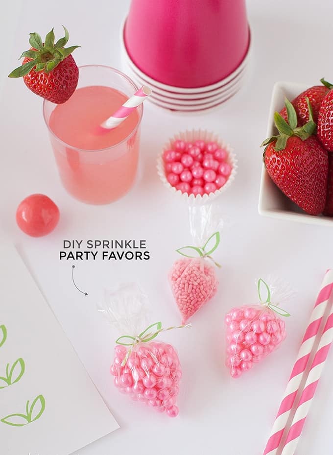 DIY Strawberry Sprinkle Party Favors | All you need is a plastic bag, string, sprinkles, and the free "leaf" printable found on Design Eat Repeat. So easy & fun!