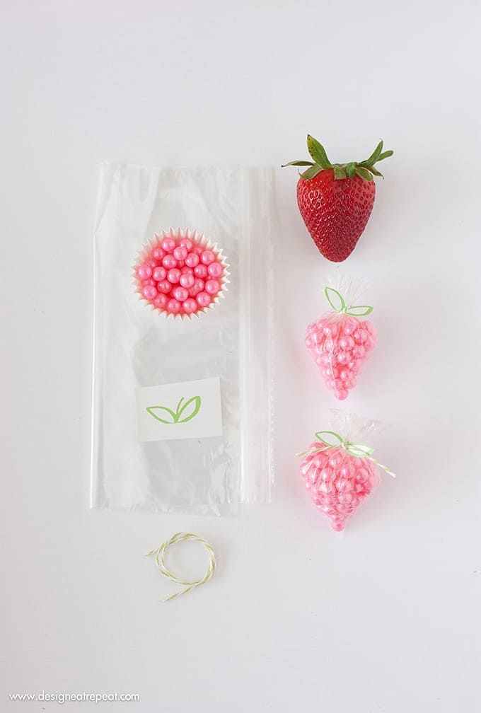 DIY Strawberry Sprinkle Party Favors | All you need is a plastic bag, string, sprinkles, and the free "leaf" printable found on Design Eat Repeat. So simple & fun!