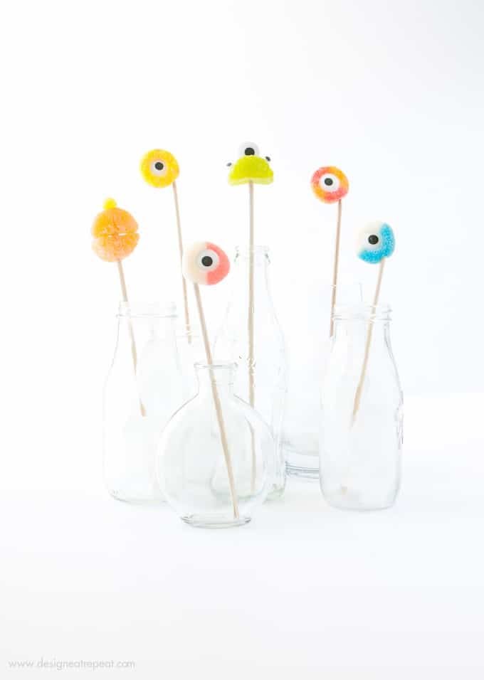 Colorful gummy candy rings on wooden skewers for halloween drink toppers