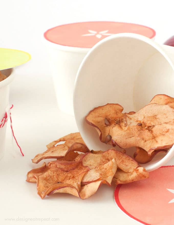 Baked apple chips in cute packaging container.