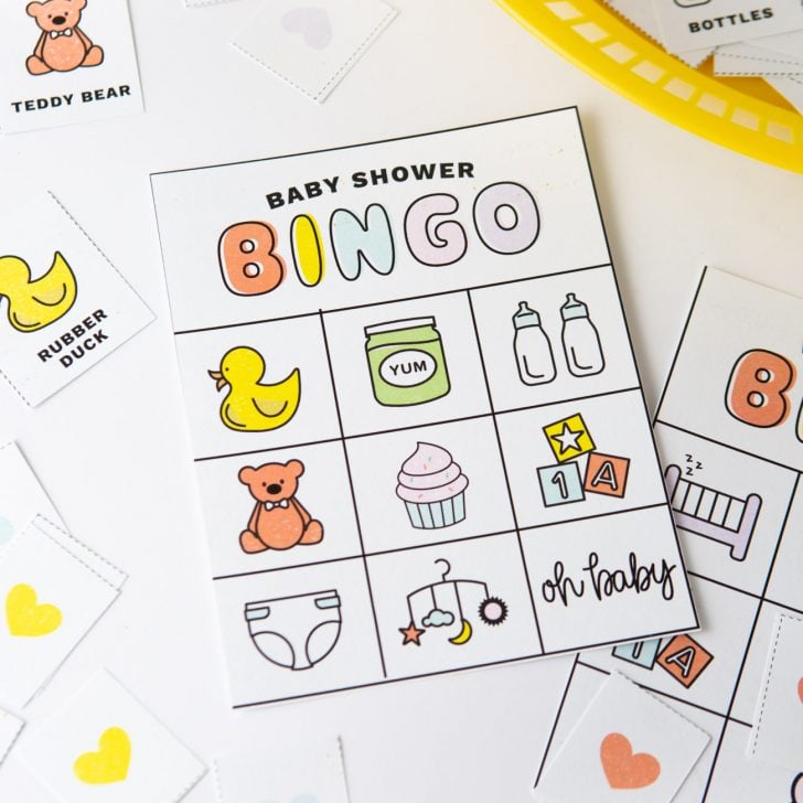 Baby shower bingo cards with pictures and icons; rubber duck, teddy bear, bottles, cupcake, diaper, blocks, baby food