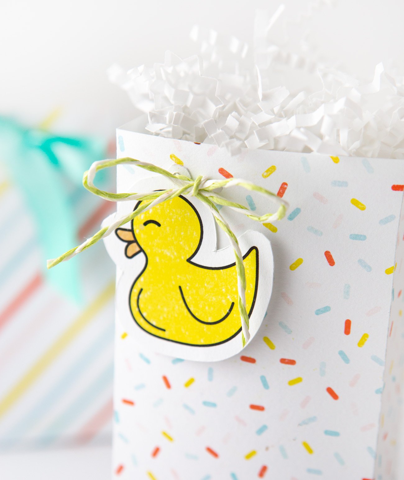 Rubber duck gift tag attached to sprinkle baby shower favor bag