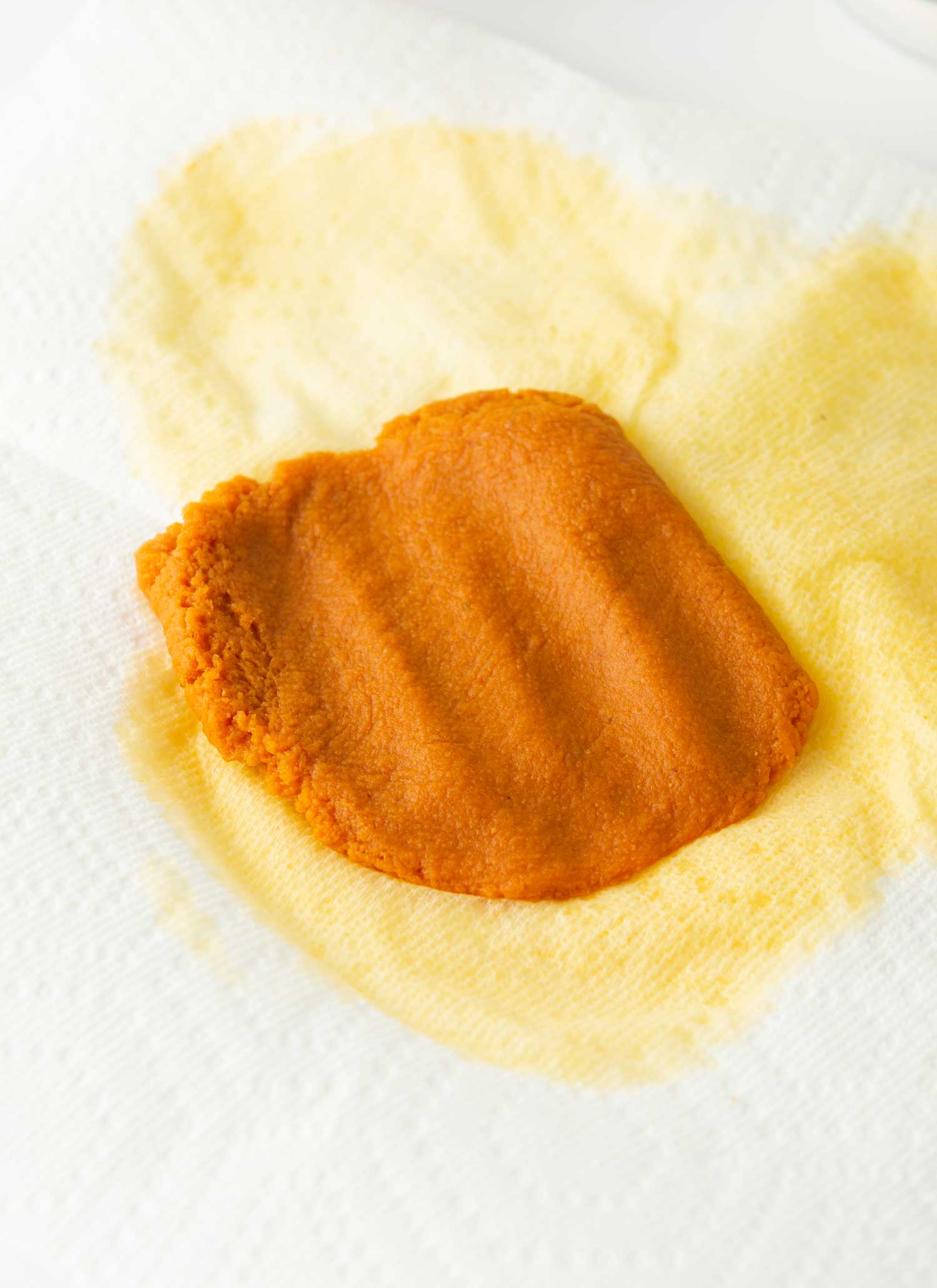 blotting water out of pumpkin puree with paper towel