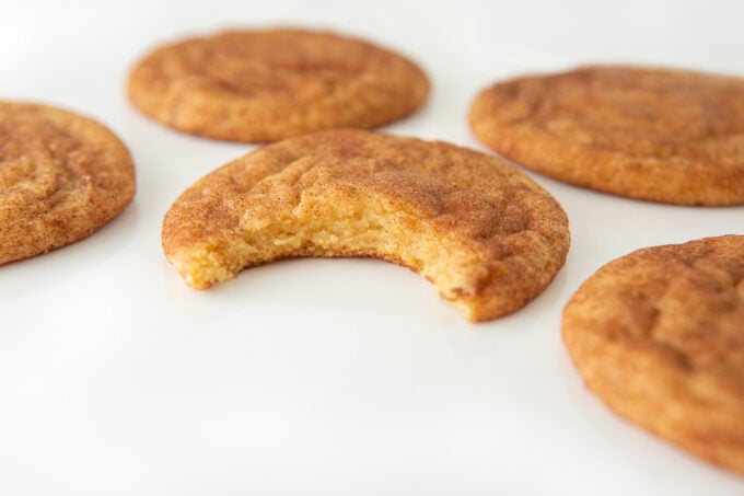 Cinnamon snickerdoodle cookie with bite to show soft texture