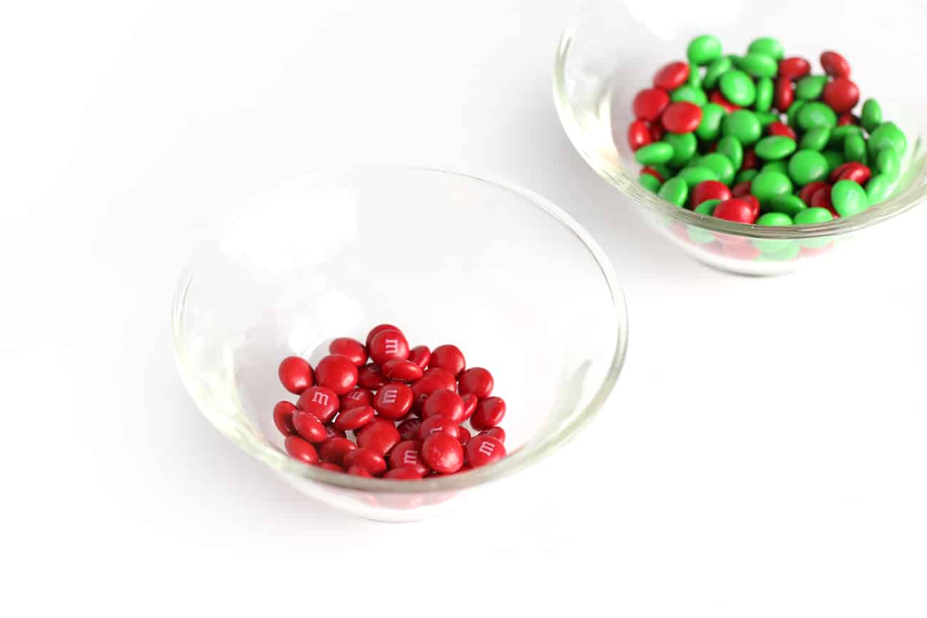 Small glass bowl of red M&M's to make easy Christmas holly cookie cups!
