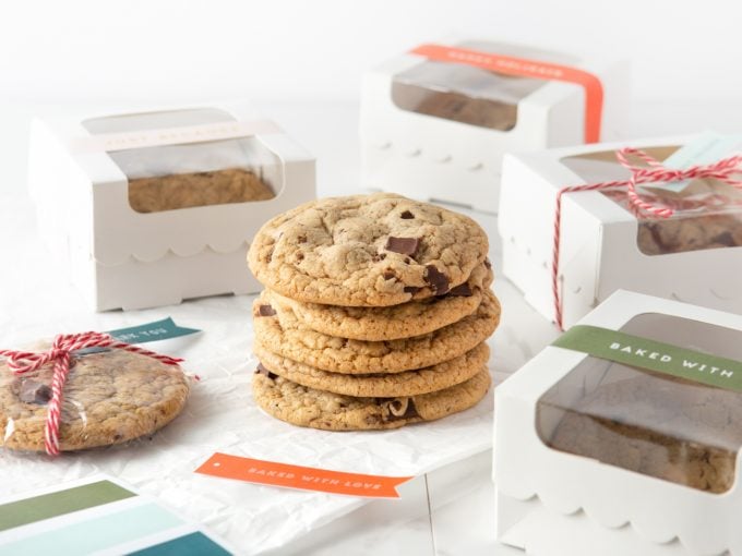 Stack of Copycat Panera Chocolate Chip Cookies with Gift Boxes and Tags