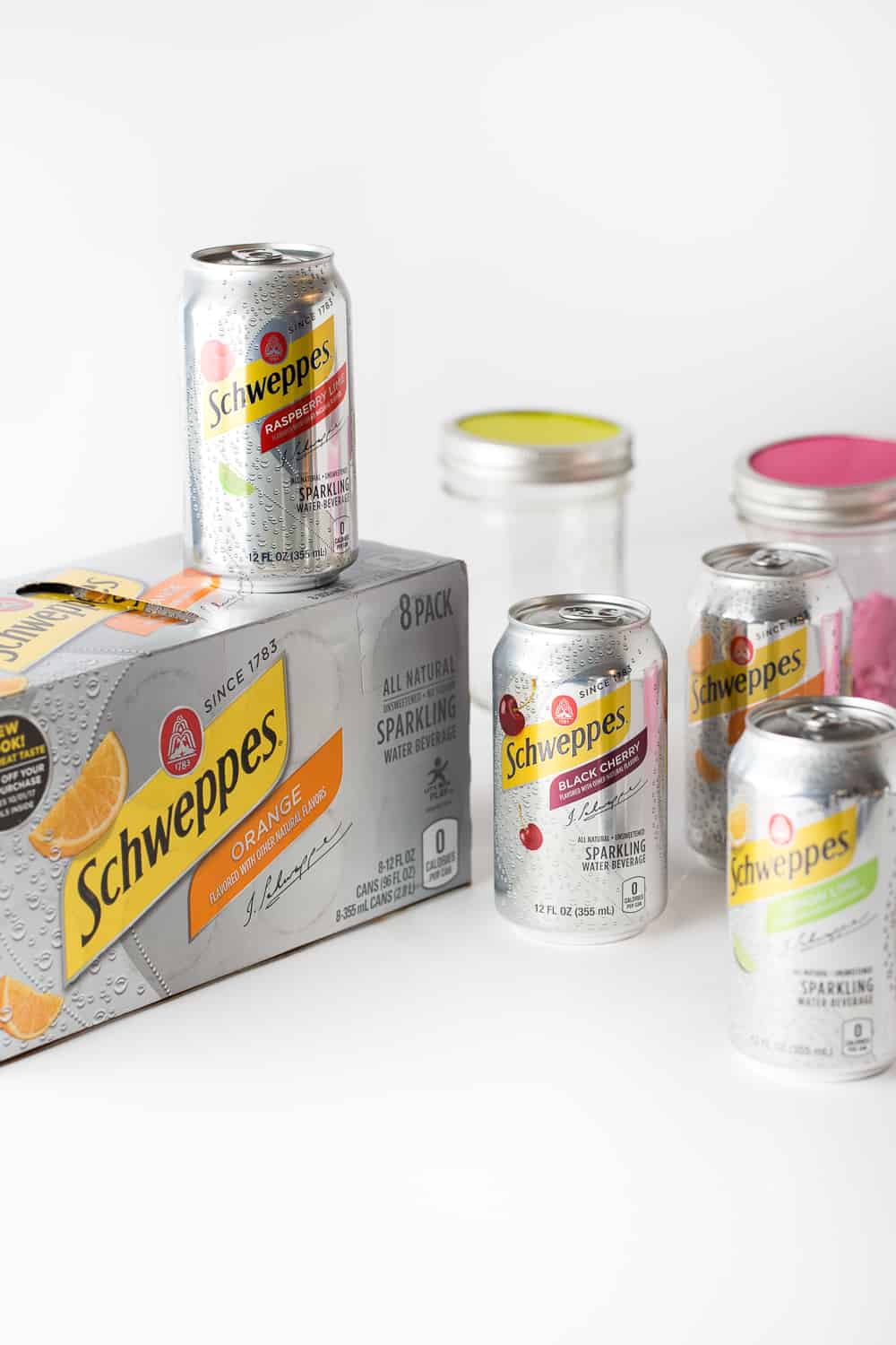 Cans of Schweppes Sparkling Water to make DIY Punch Bar