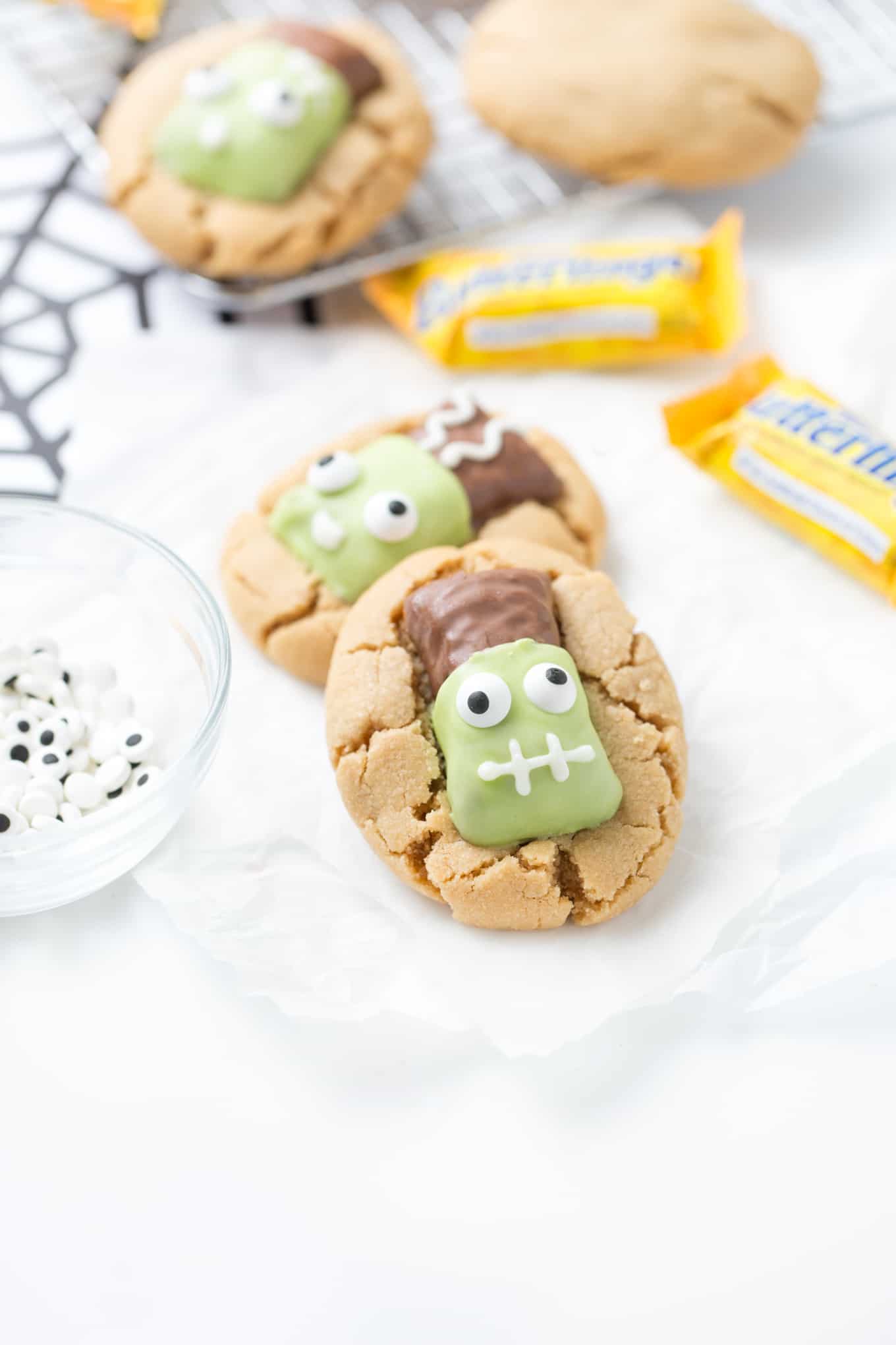 Peanut Butter Cookies topped with Frankenstein Butterfingers Candy Eyeballs
