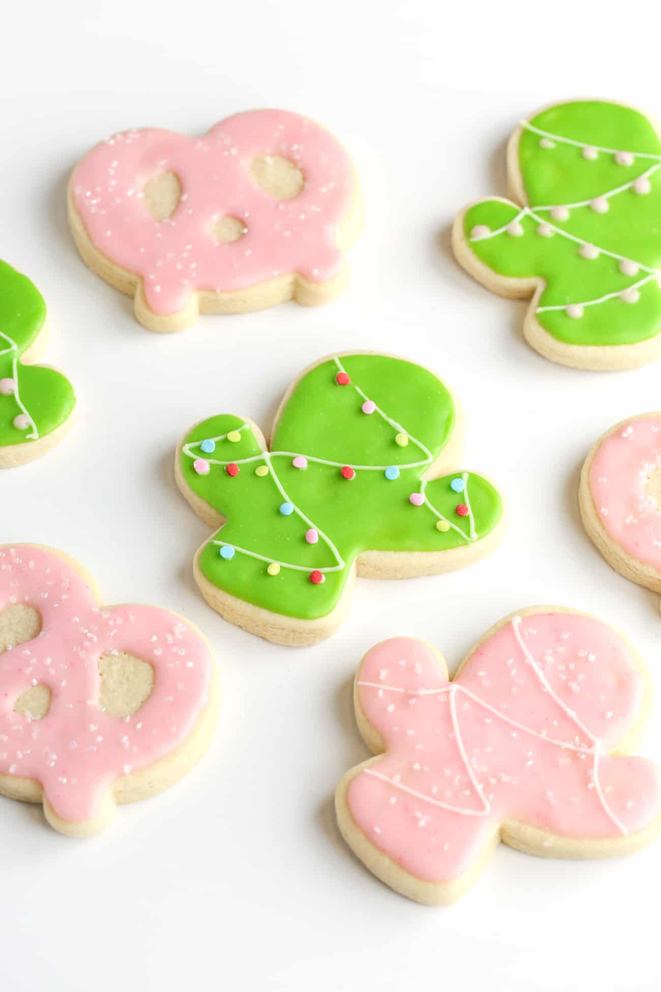 Christmas cactus green sugar cookies, pink cactus sugar cookies, and pink pretzel sugar cookies.