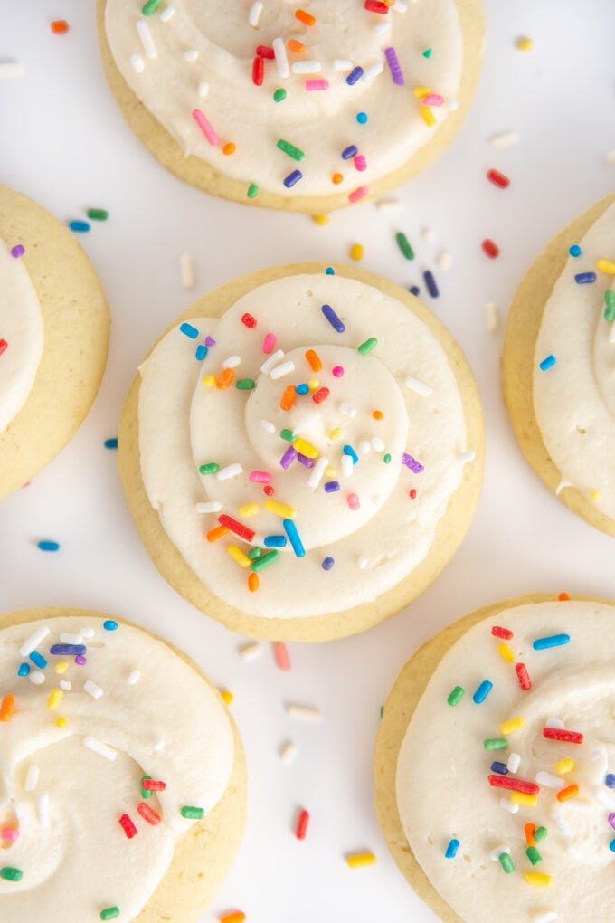 fluffy sugar cookies with frosting and rainbow sprinkles