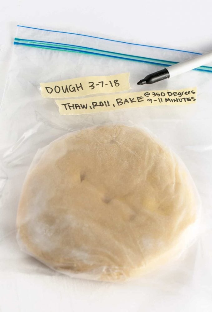 Plastic bag of sugar cookie dough disc with tape notes