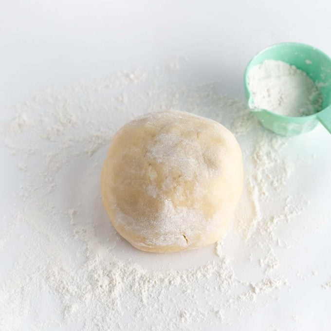 Ball of sugar cookie dough with flour dusted