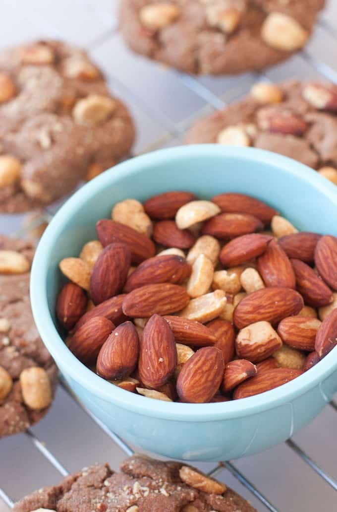 Blue bowl of almonds sitting on top of wire cooling rack.