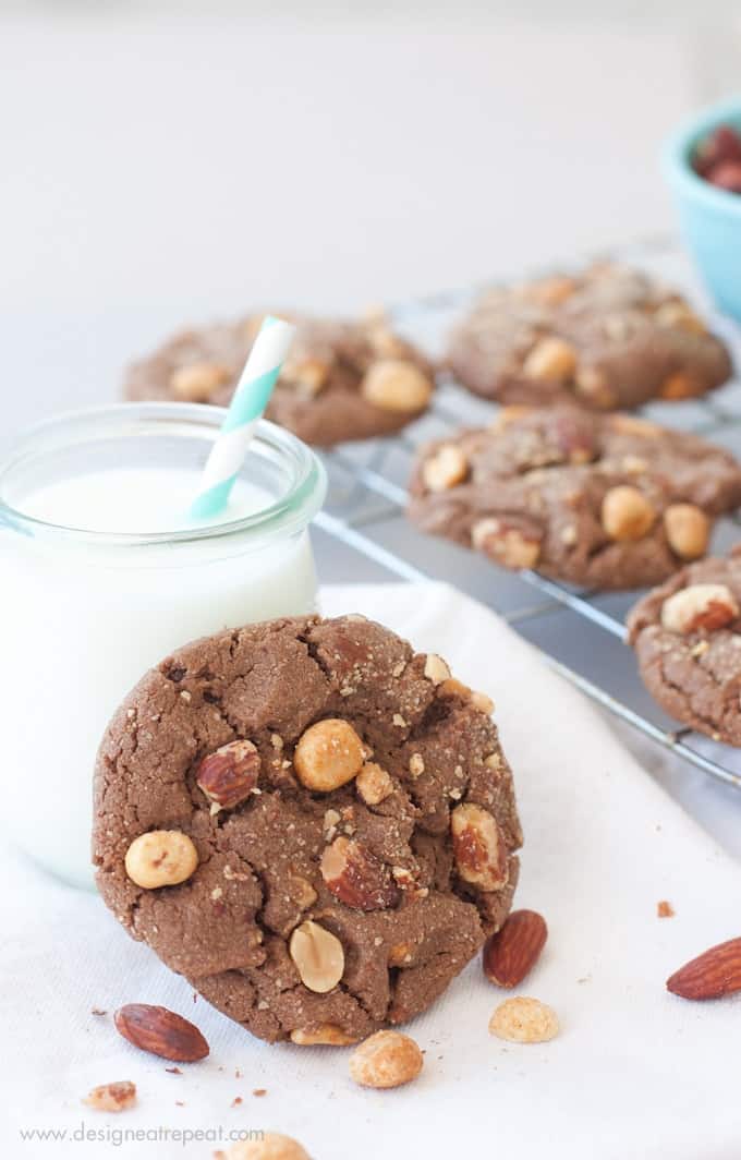 Milk Chocolate Peanut Butter & Almond Cookie leaning against jar of milk.