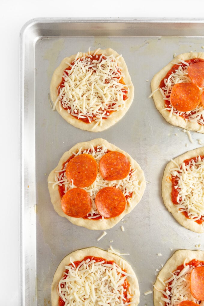 mini pizza dough with sauce, cheese and pepperoni toppings