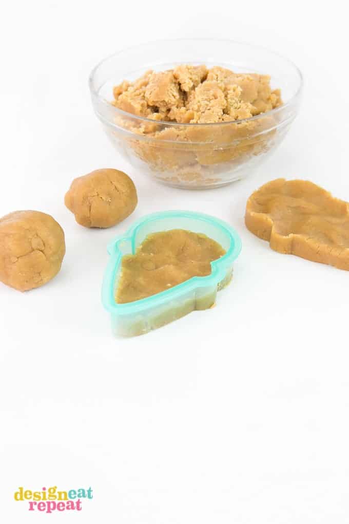 Pressing peanut butter cookie dough into plastic Sugarbelle ice cream cone cutter.