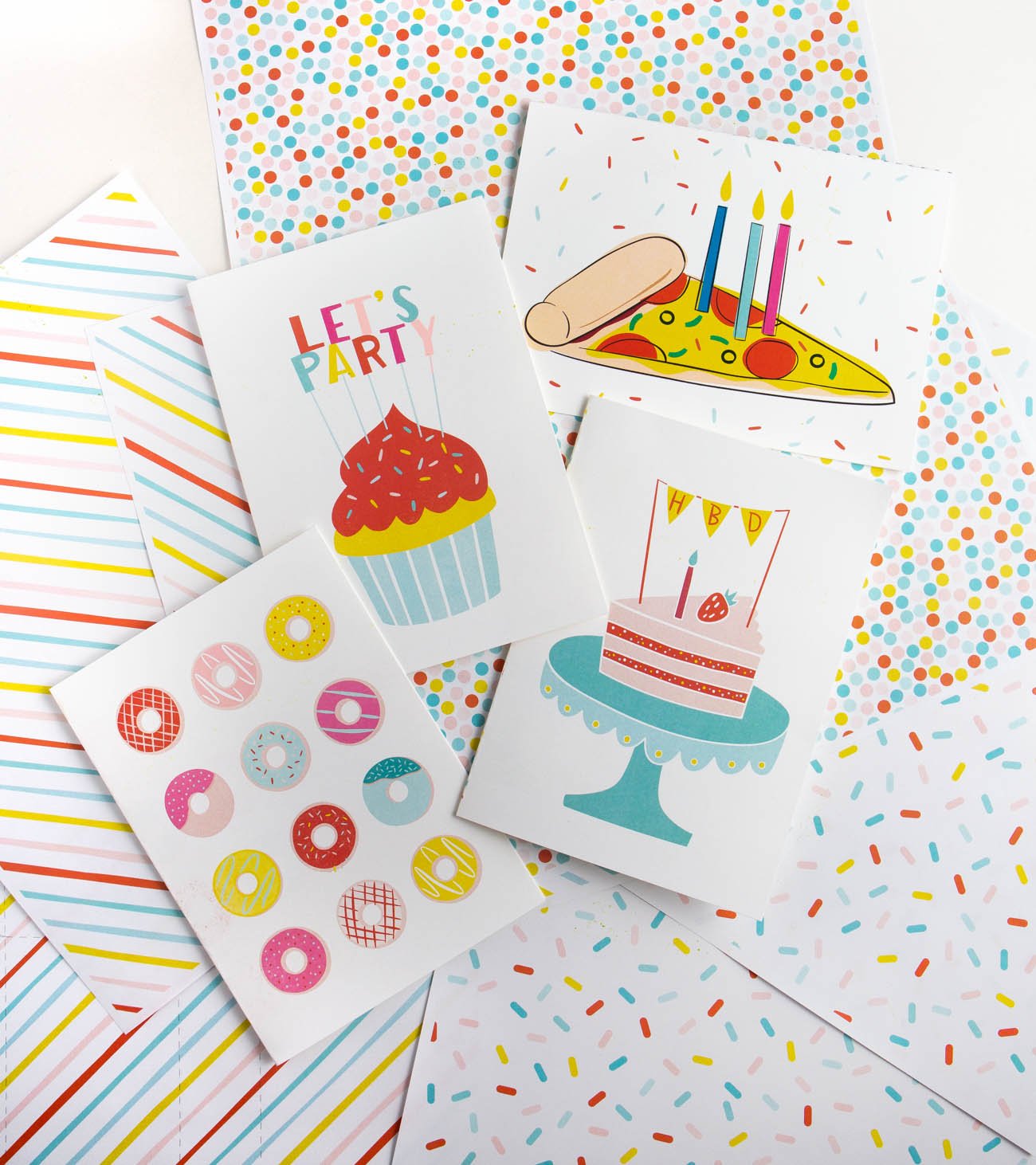 Four free printable birthday cards with donuts, cupcake let's party, pizza, and cake with HBD message