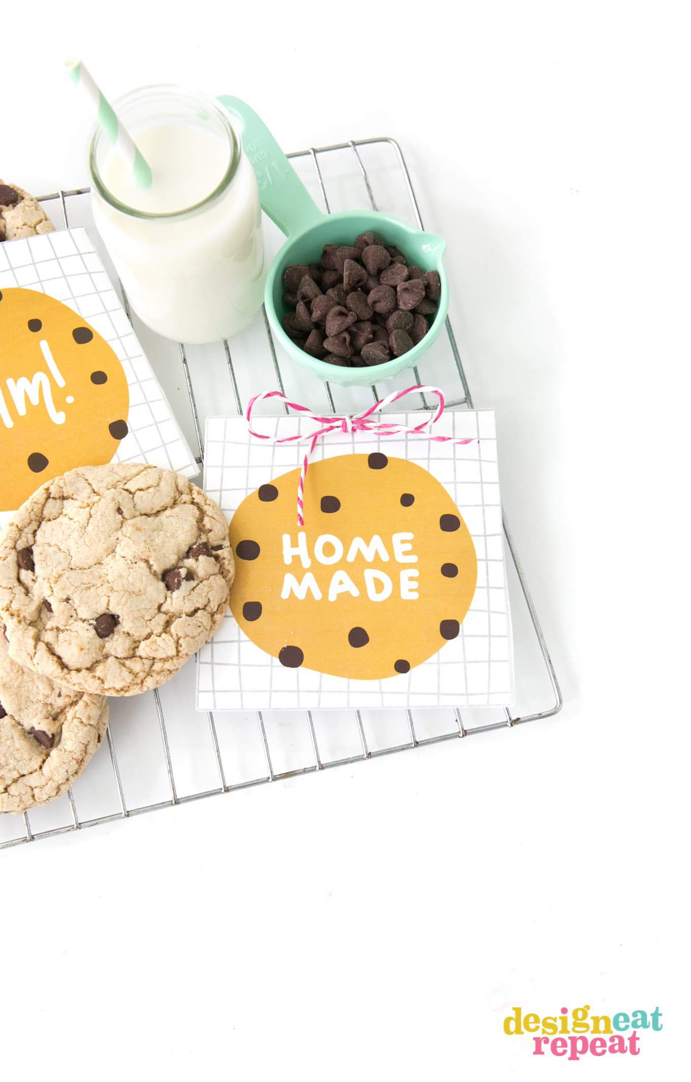 Chocolate chip cookie bag that says "Homemade" on top on cooling rack with jar of milk.