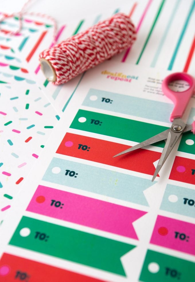 Printed sheet of green, red, pink, and blue printable Christmas gift tags "TO"