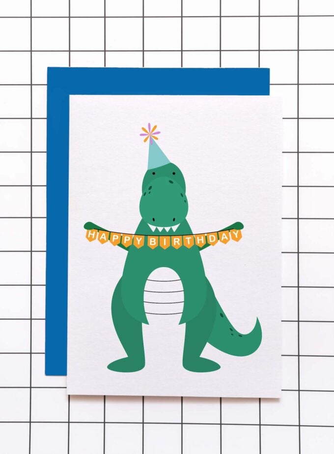 Greeting card of green dinosaur holding happy birthday banner