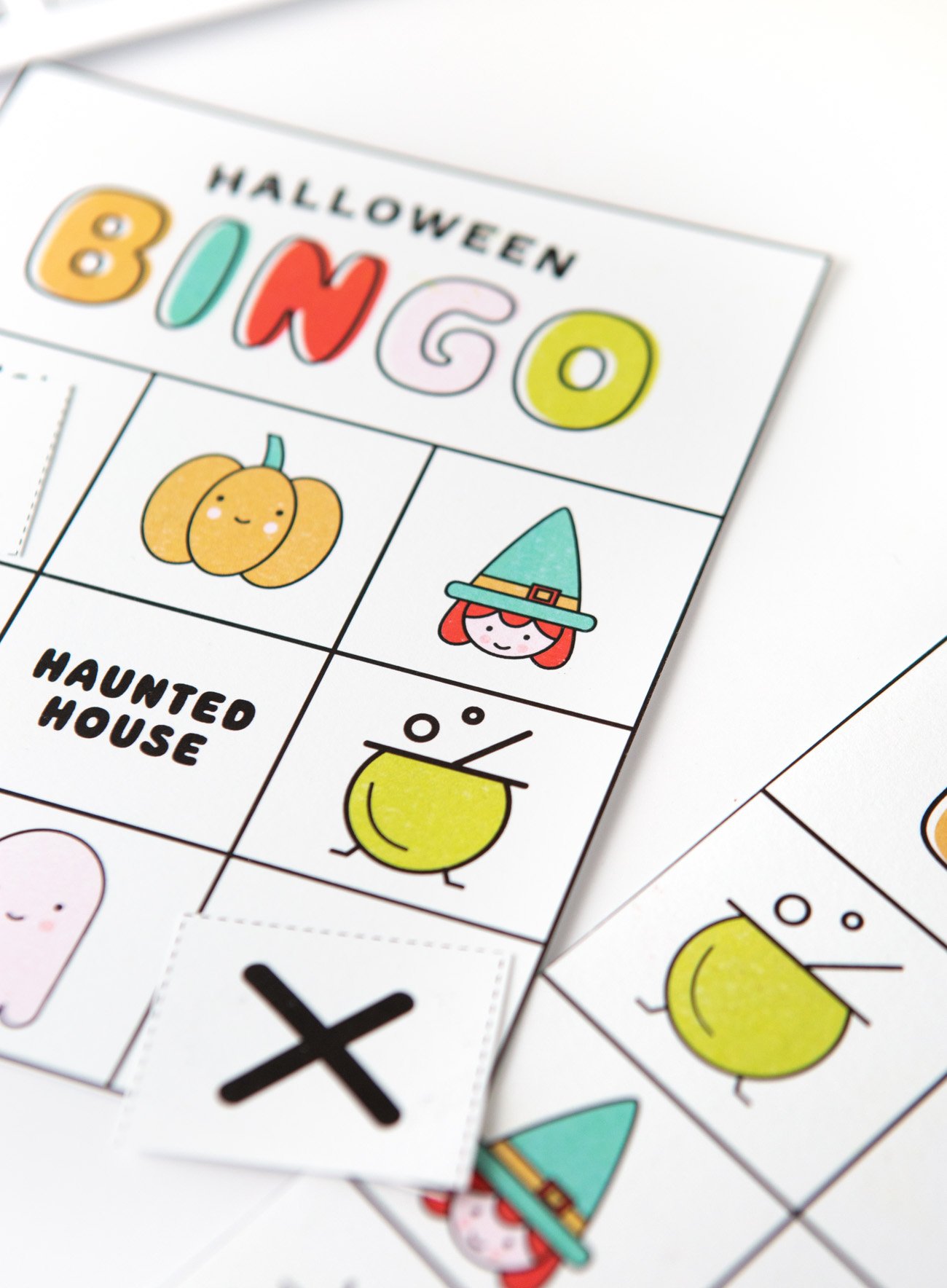 Colorful free printable Halloween bingo cards with icons and pictures: pumpkin, witch, lollipop, cauldron, spider, ghost