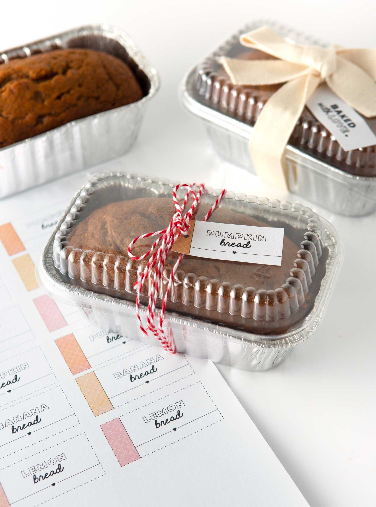 pumpkin bread gifted in disposable foil pan with red string and gift tag