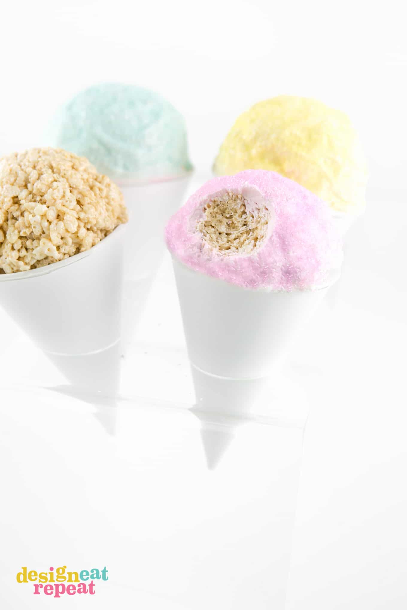 Pink rice krispie snowcone with bite taken out of top.