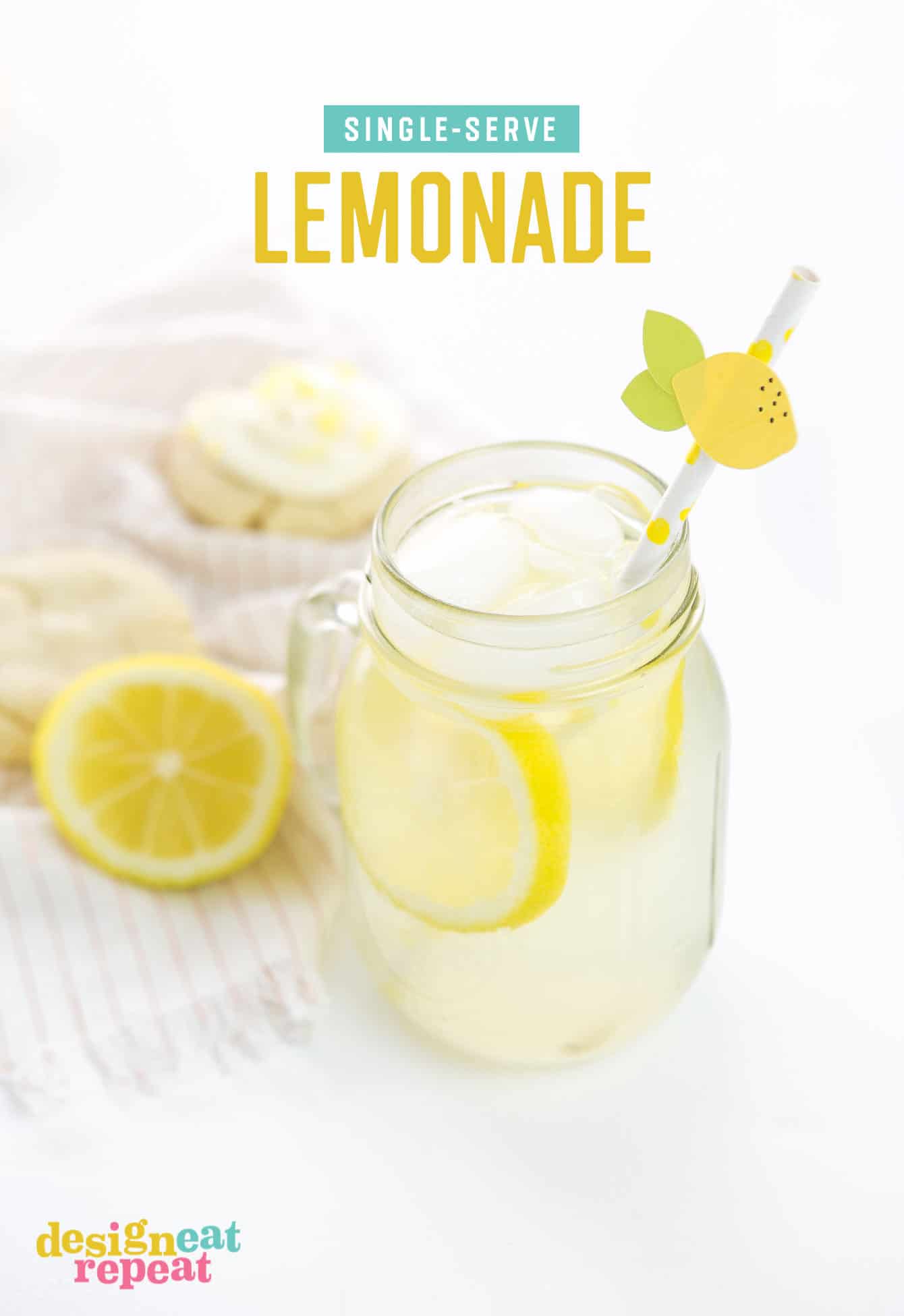 Mason jar of freshly squeezed lemonade with paper straw and lemon topper.