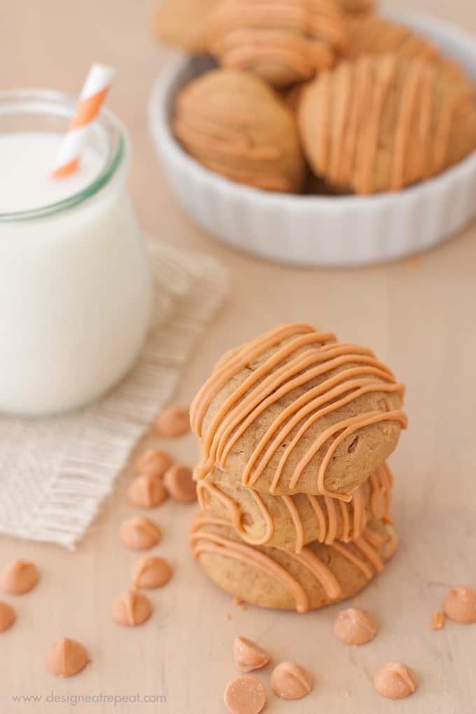 Stack of 3 Soft Butterscotch Pumpkin Spice Cookies on wooden table with milk jar in background