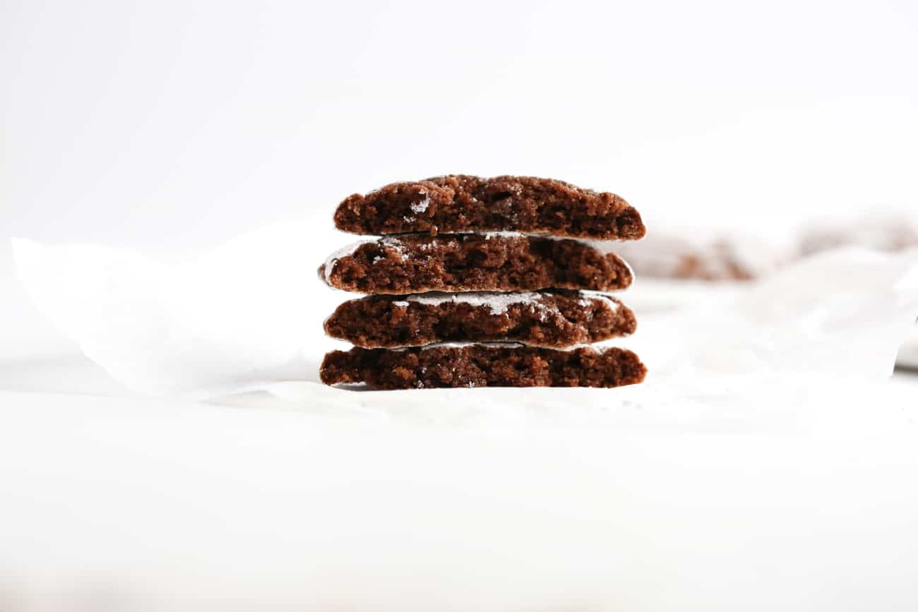 Stack of chocolate brownie cookies cut in half.
