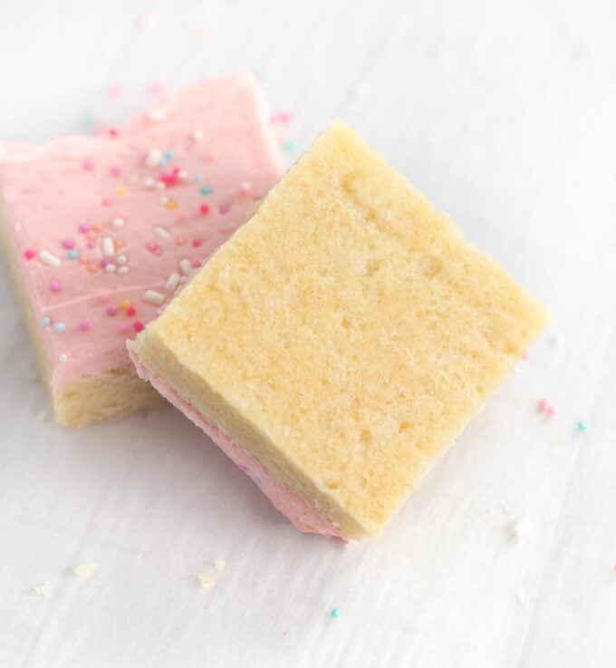 bottom of frosted sugar cookie bars with pink frosting and sprinkles