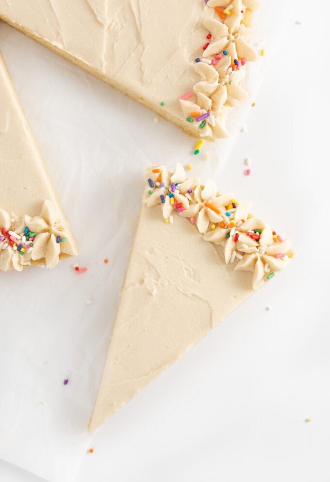 slice of sugar cookie cake with buttercream and sprinkles