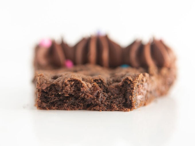 slice of triple chocolate cookie cake with bite to show soft texture