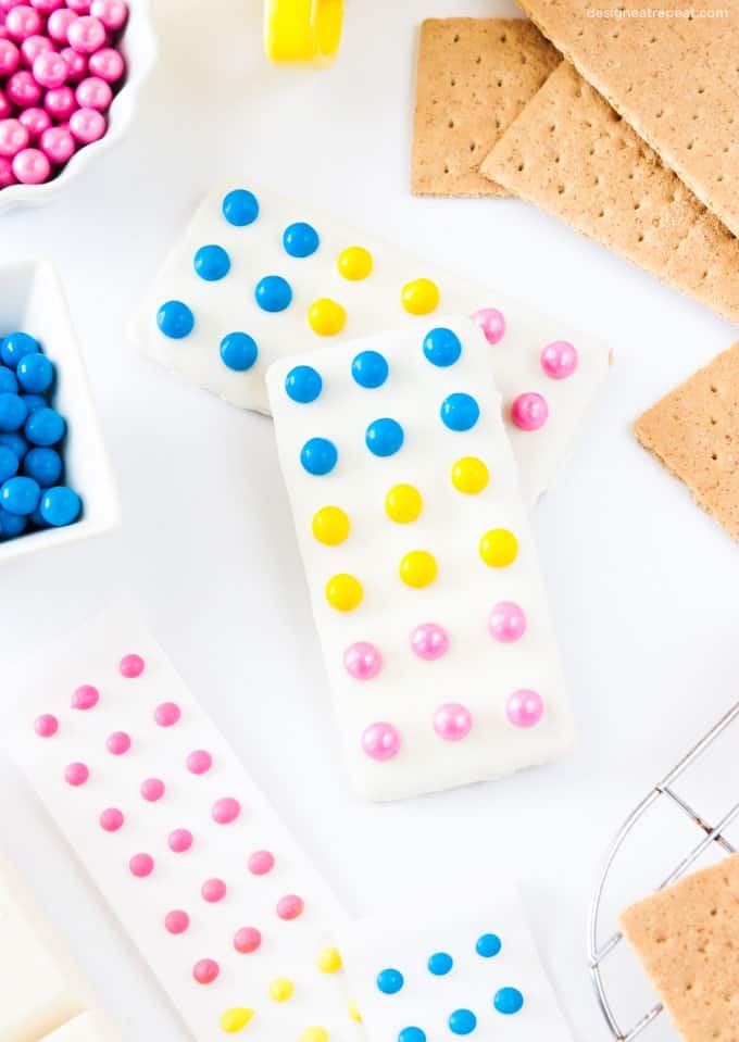 Turn graham crackers into candy button bars with almond bark & Sixlets!