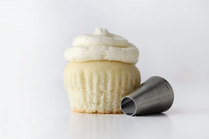 White wedding cupcake with piping tip.